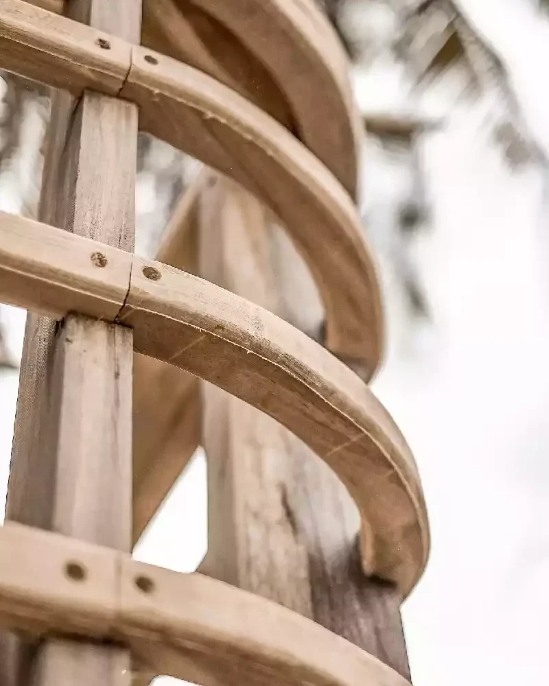 Close-up of curved wooden hull frames fastened with wooden dowels on a phinisi under construction